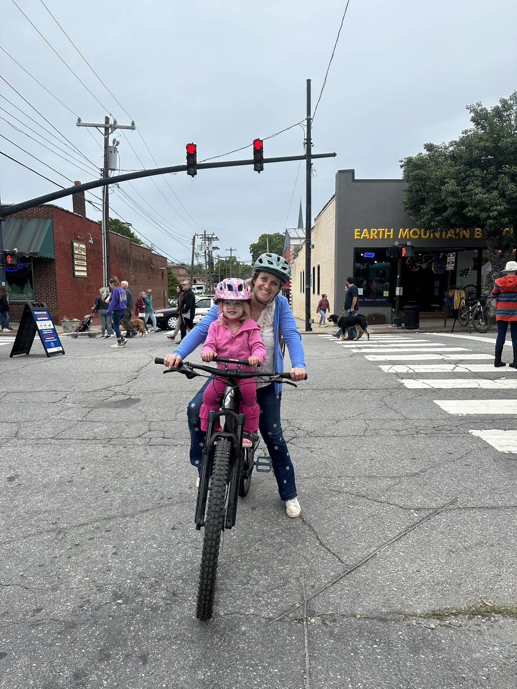 Sarah and her daughter Em on a bike in downtown Brevard